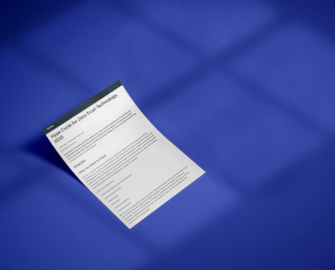 A single sheet of paper with printed text titled “Hype Cycle for ZeroTrust Technology, 2023” rests on a flat blue surface, illuminated by soft, diagonal shadows. The text is partially readable, and the background is plain.